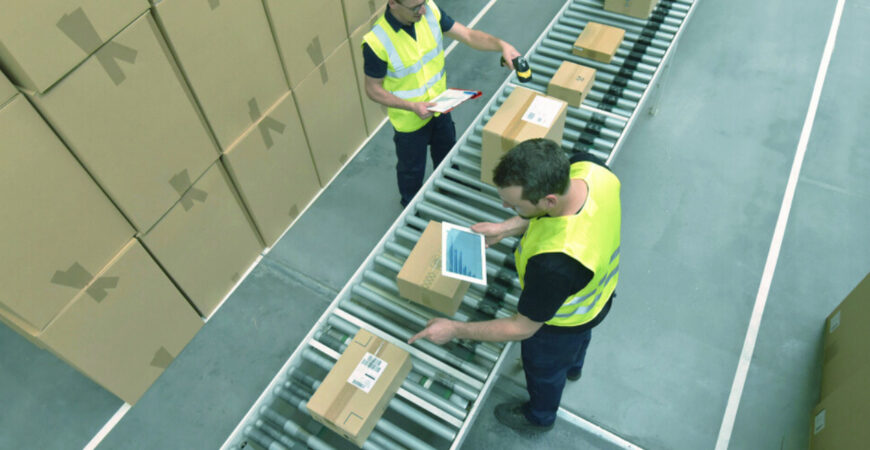warehouse workers scanning packed packages along a conveyor belt direct to consumer fulfillment