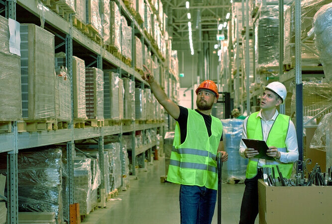 two warehouse logistic workers using FEFO as a means of inventory management