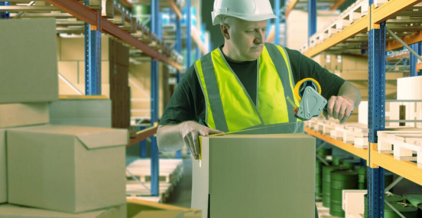A fulfillment center employee preparing packages for shipment