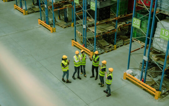 fulfillment center employees standing in a huddle