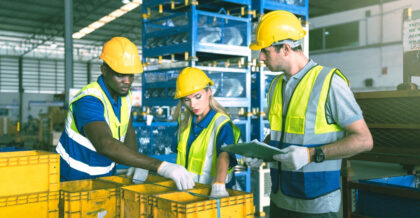 Group of warehouse workers working together to figure out best inventory stratgey between just in time and just in case.