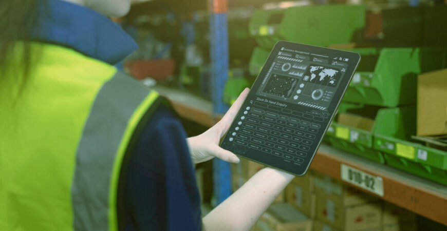 inventory manager worker using warehouse management system on tablet computer for tack checking products lots storage location
